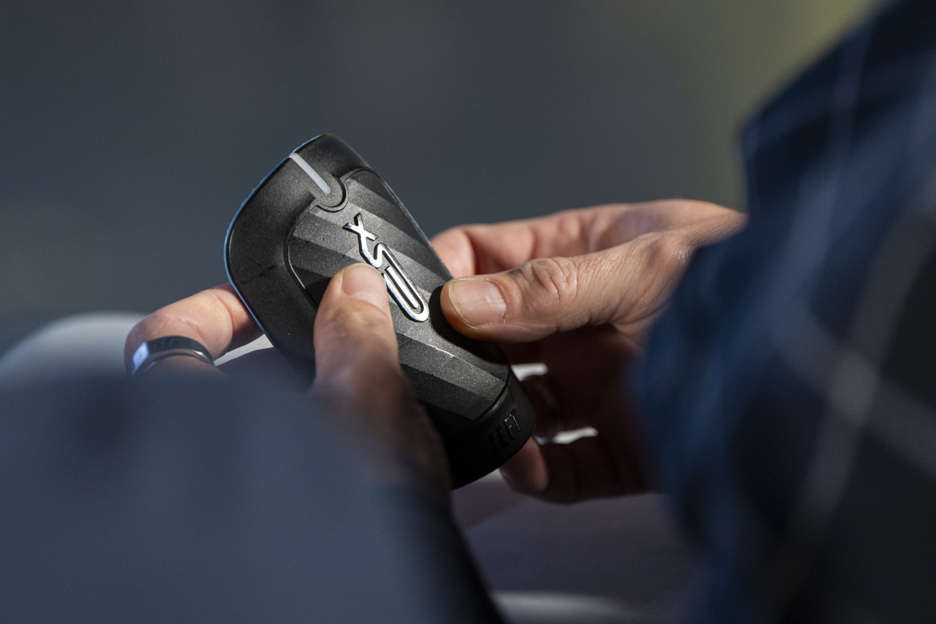 Hands holding XSEED smart shinguards