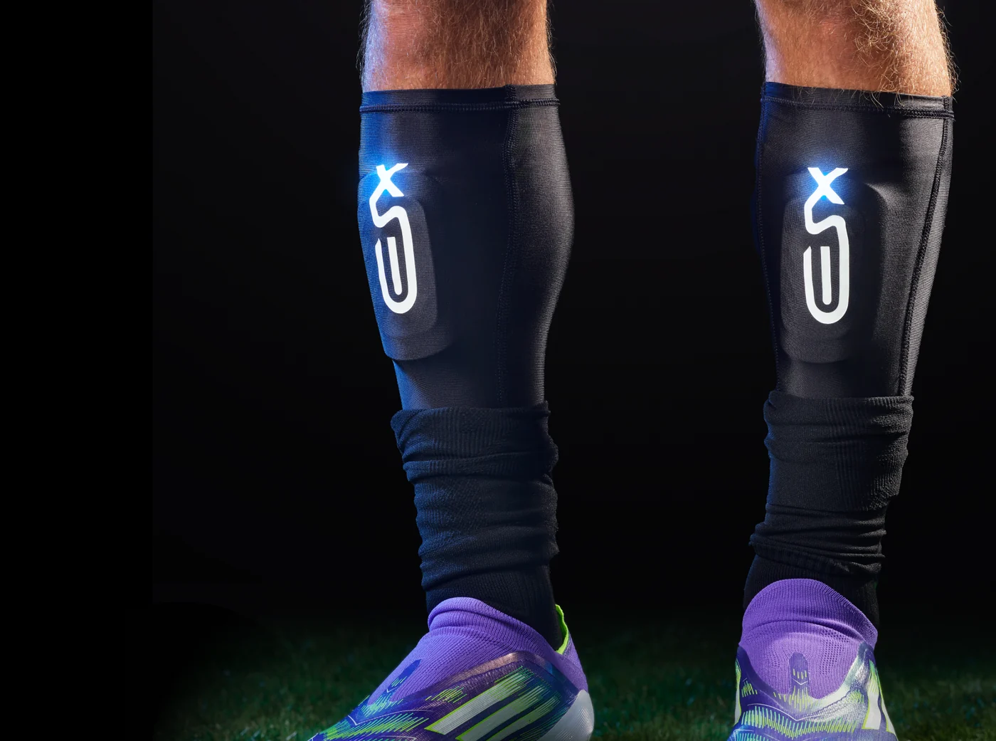 XSEED smart shinguards worn on the pitch with the illuminated logo